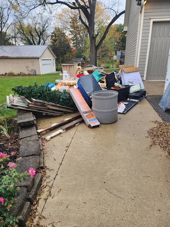Dumpster being loaded with debris for Demolition Dumpster Rental in Hill 'n Dale
